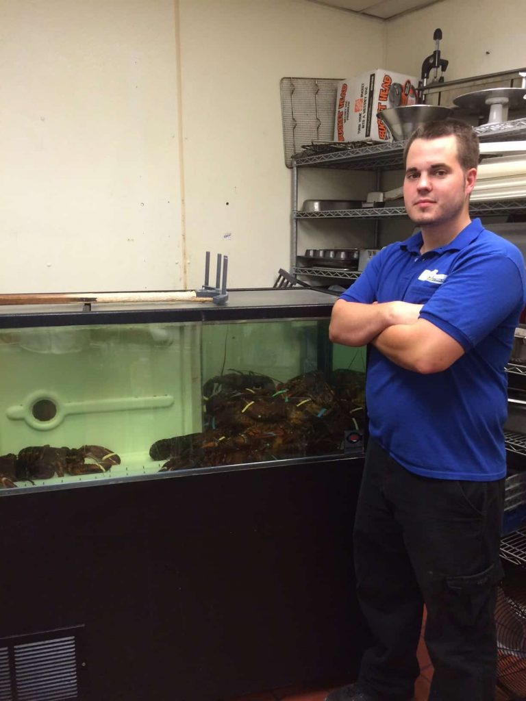 Denton Gallagher makes an emergency repair to the lobster tank